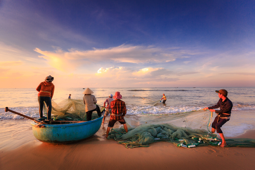 Fishermen With Nets On The Shore